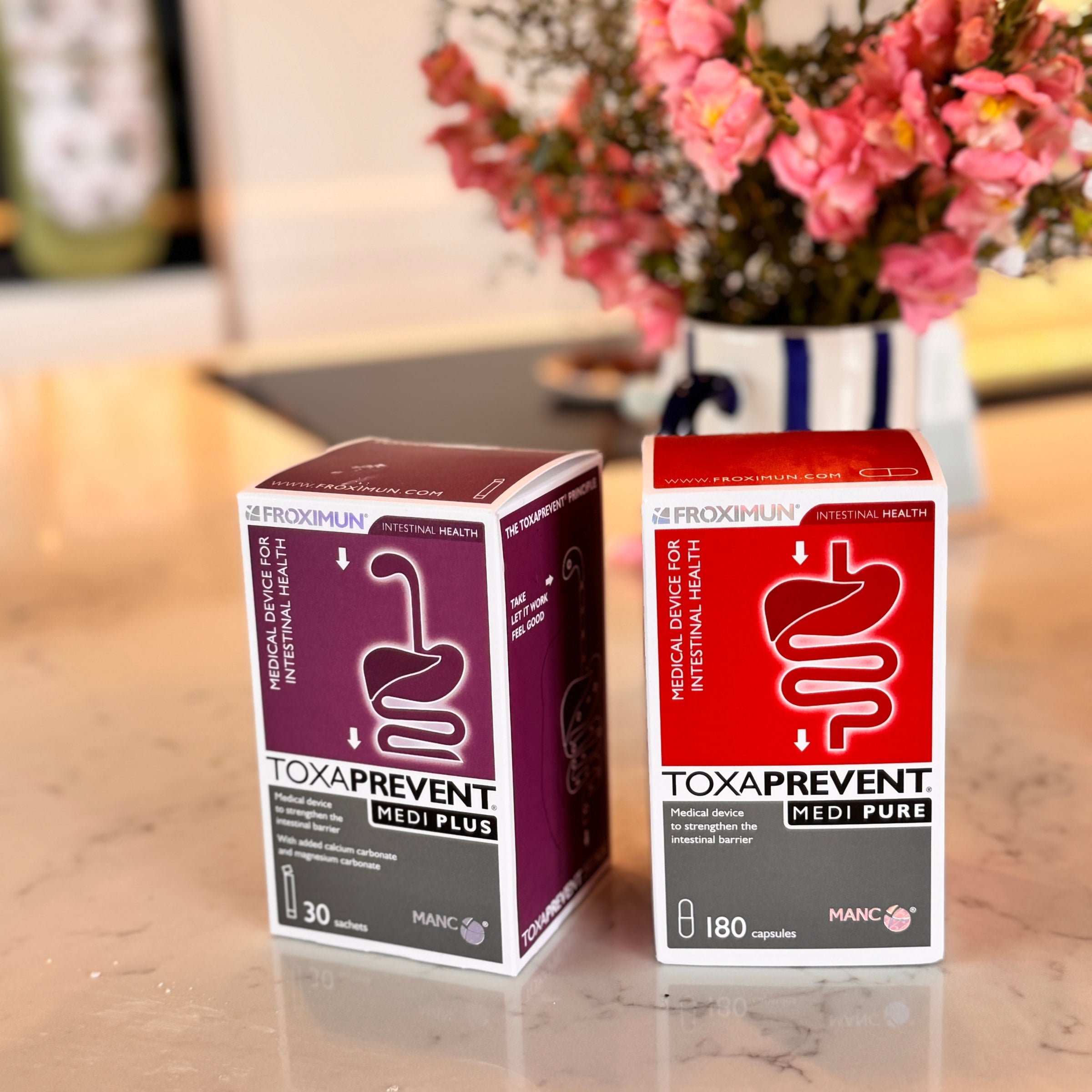 Zeolite Clinoptilolite for Histamine Intolerance. Image of Toxaprevent Sachets and Toxaprevent Capsules on table in home with flowers. Natural hay fever and allergy support. Support hay fever naturally